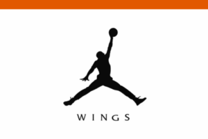 Silhouette of a basketball player jumping with one arm extended holding a ball, above the word “WINGS” in capital letters.