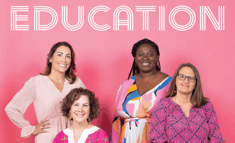 Four women stand in front of a pink background with the word EDUCATION written above them