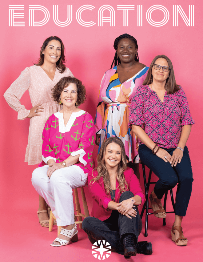 Five women in colorful outfits pose together against a pink background with the word EDUCATION in large white letters above them